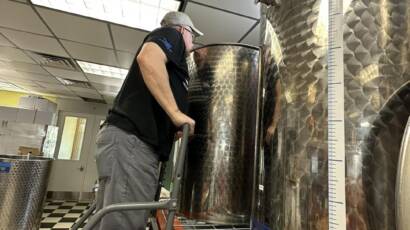 man working in the backroom of a winery